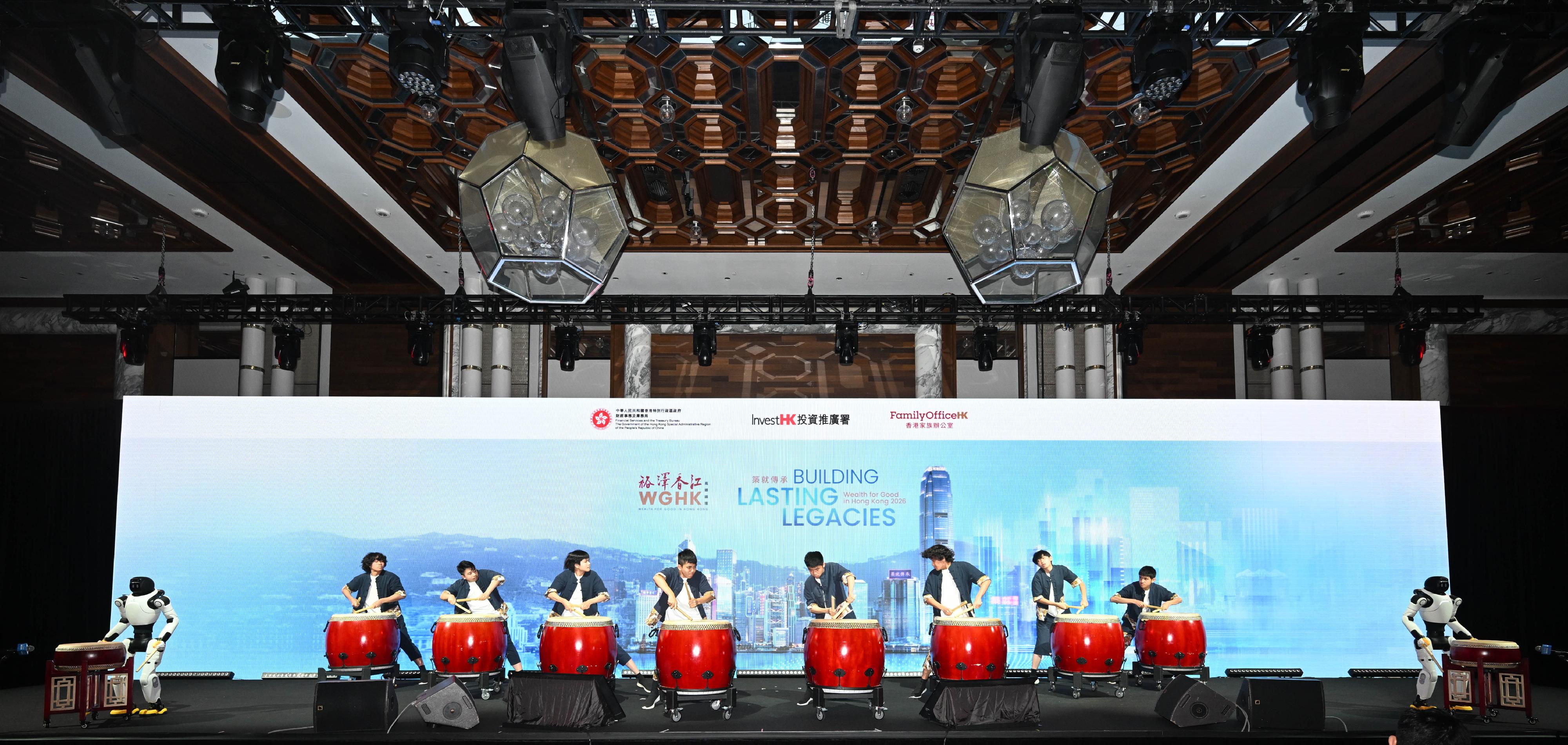 The Diocesan Boys' School Chinese Drum Team and robotic drummers perform a joint ensemble at the opening of the Wealth for Good in Hong Kong Summit today (March 24), showcasing the integration and coexistence of traditional arts and cutting-edge technology.